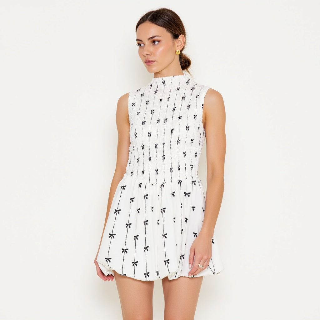 Sleeveless Smocked Mini Dress with High Neckline and Embroidered Bow Motif