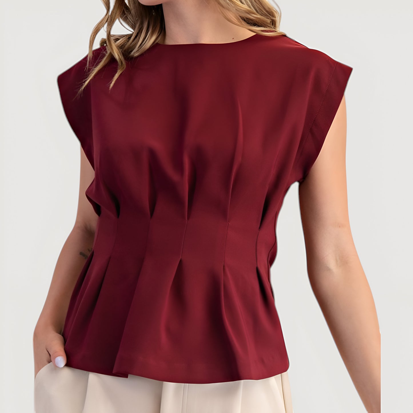 Cap Sleeve Peplum Top with Structured Pleats and Round Neckline
